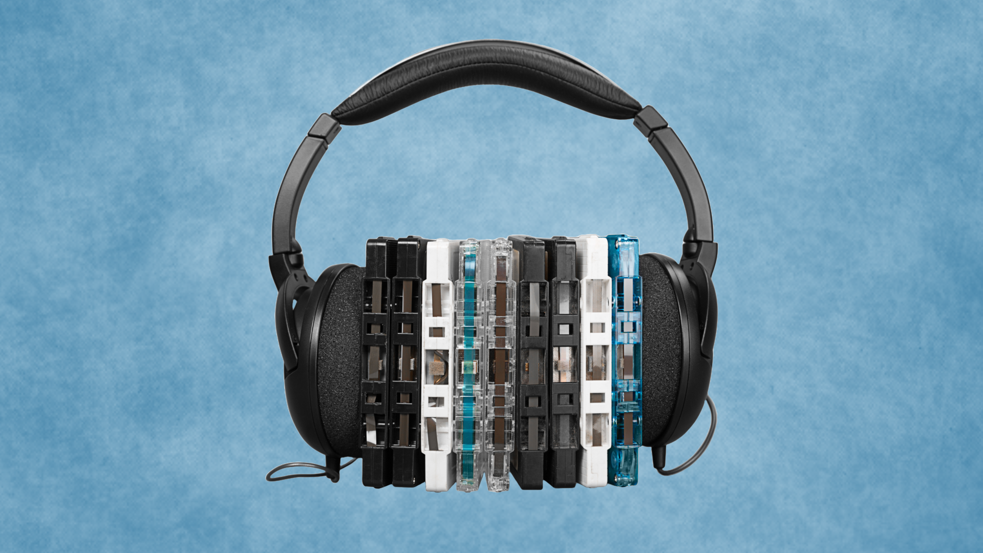 Image of headphones and cassette tapes with a blue background